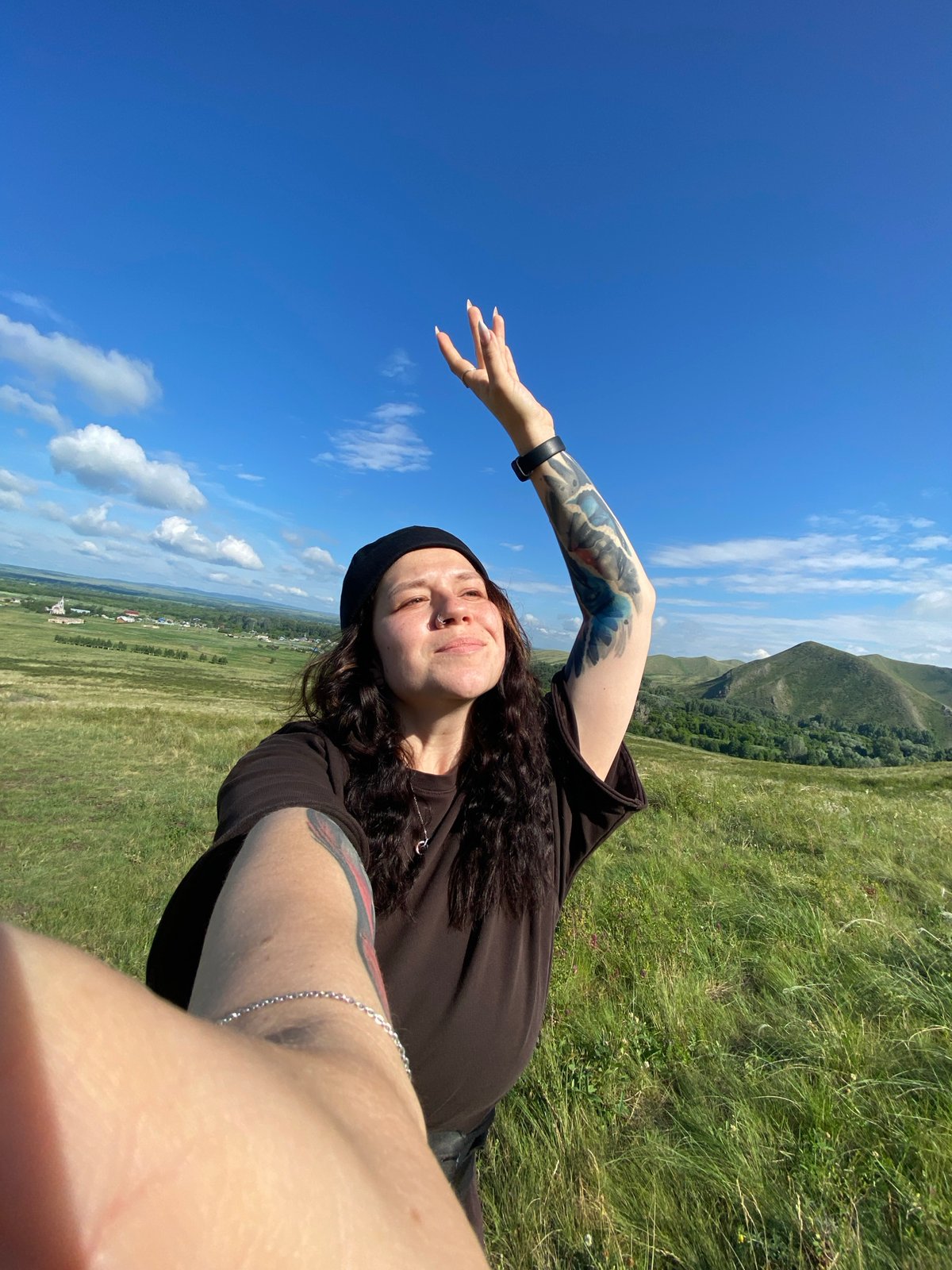 Woman takes outdoor selfies on hill in Andreevka, Russia