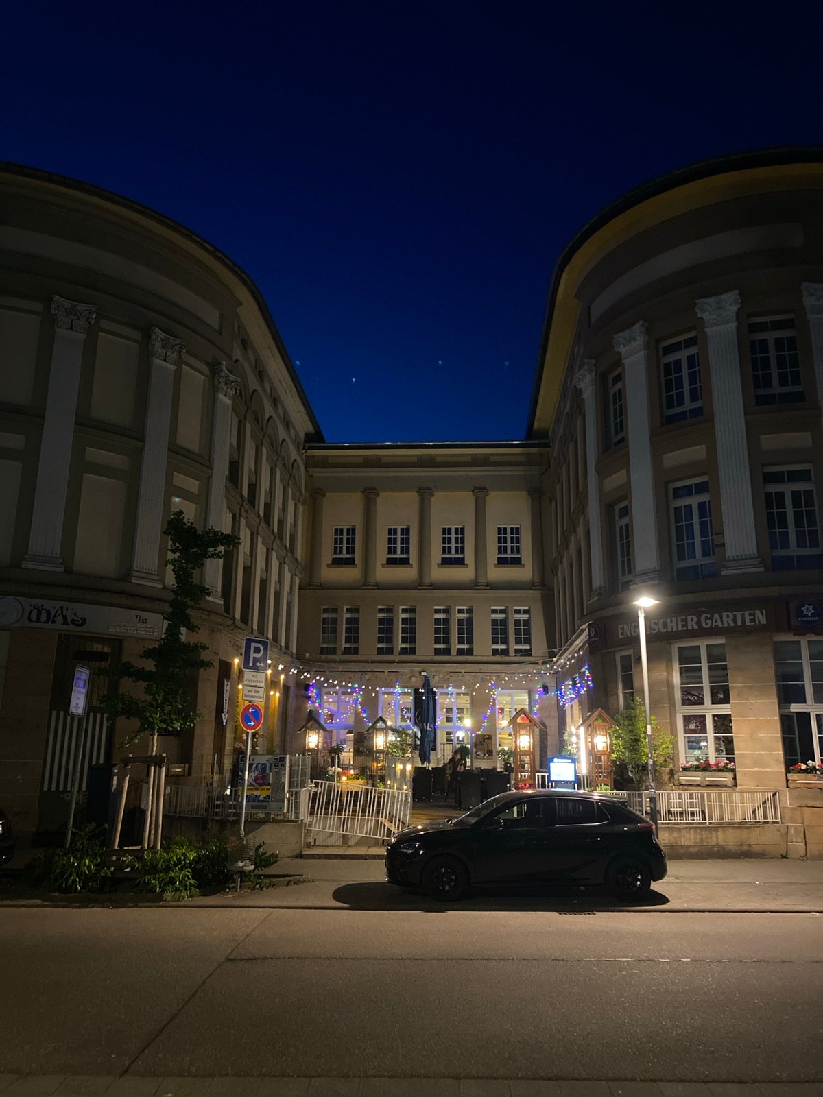 Evening photography captures Landau's restaurant district and illuminated church