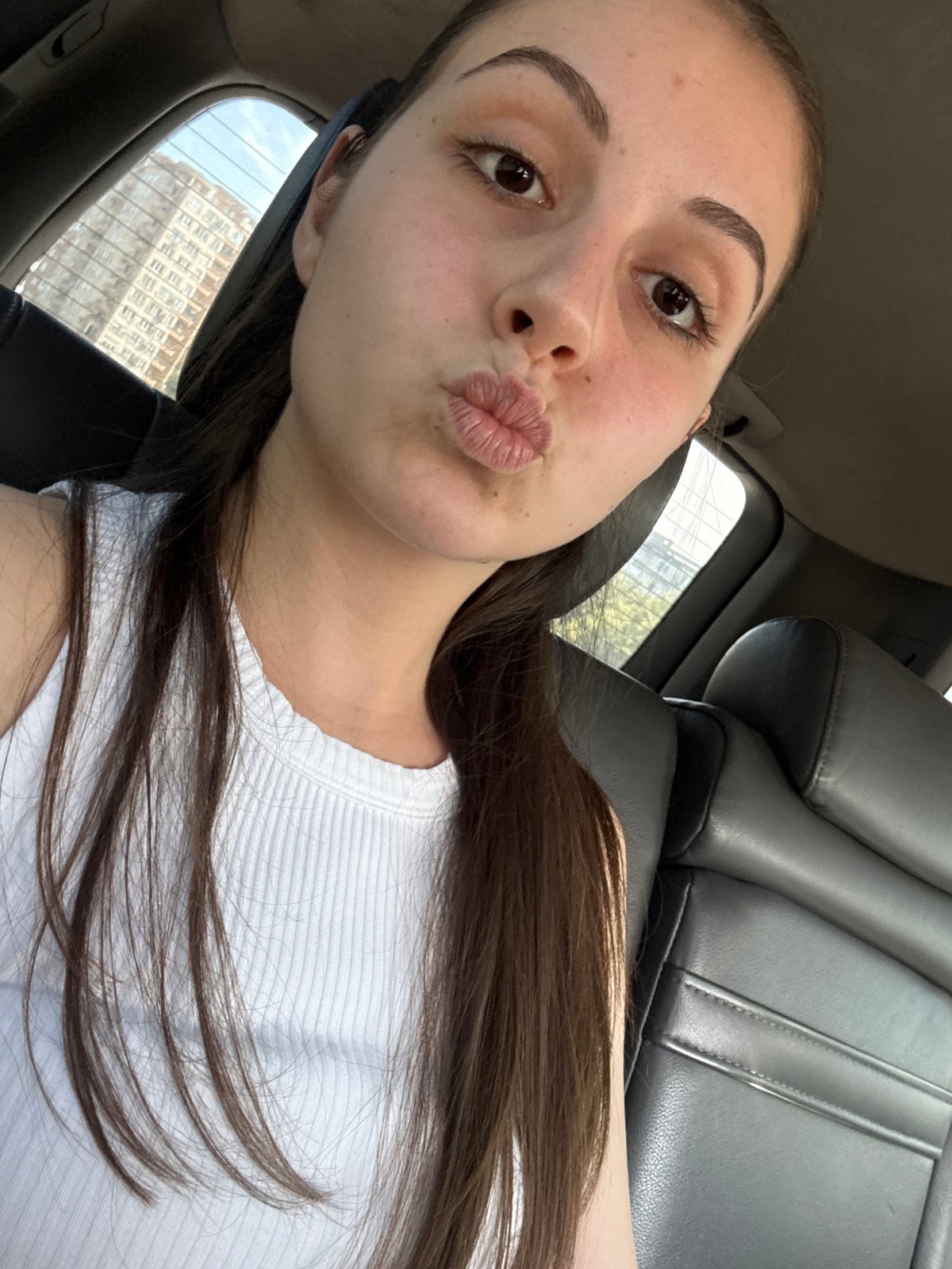 Woman takes playful car selfies in Burgas, Bulgaria