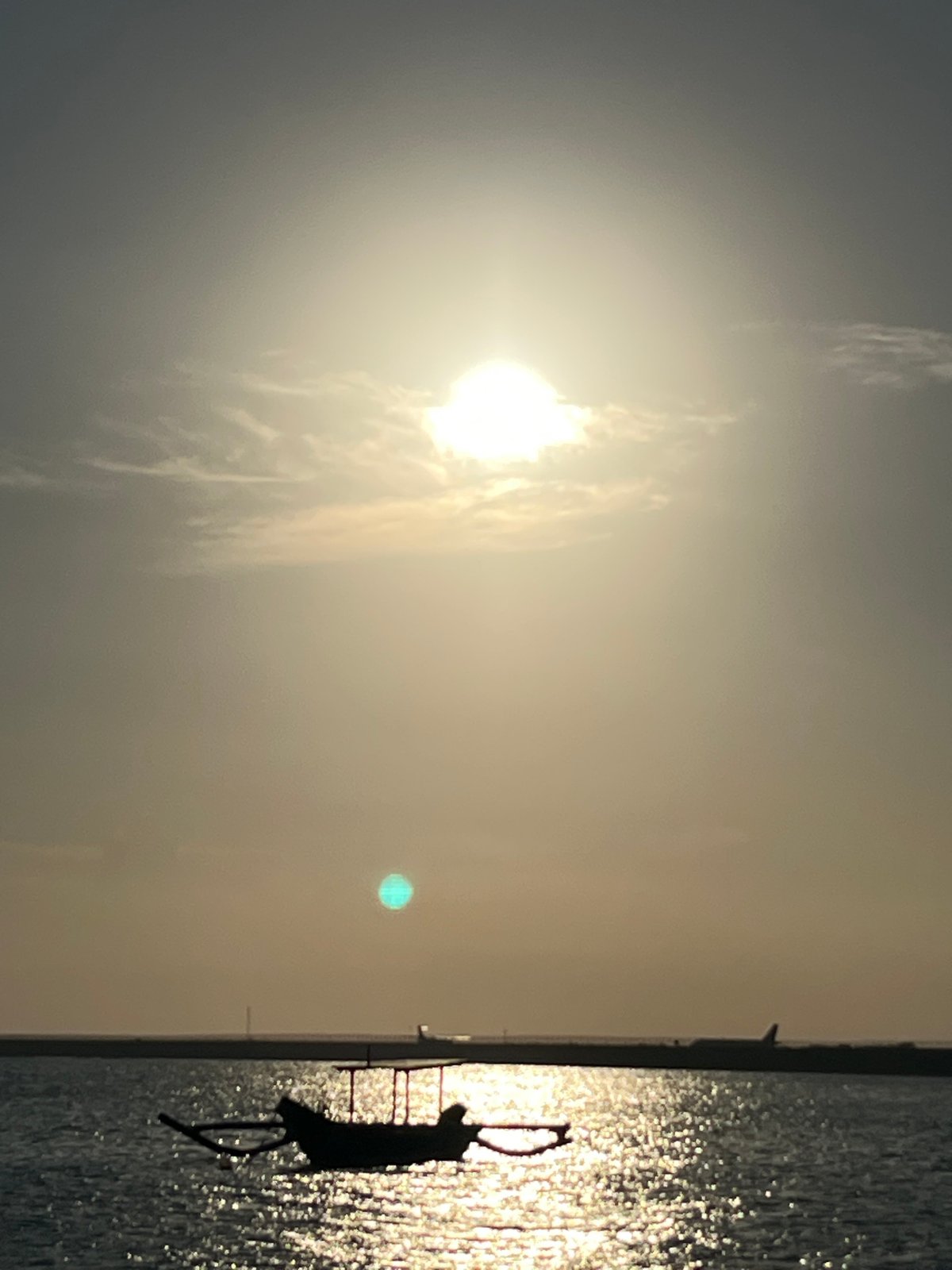 Golden hour at Kuta Beach with boats, games, and sunset selfies