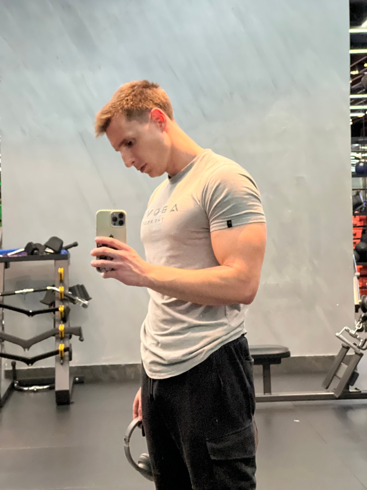 Man uses phone at Burgas gym during afternoon workout