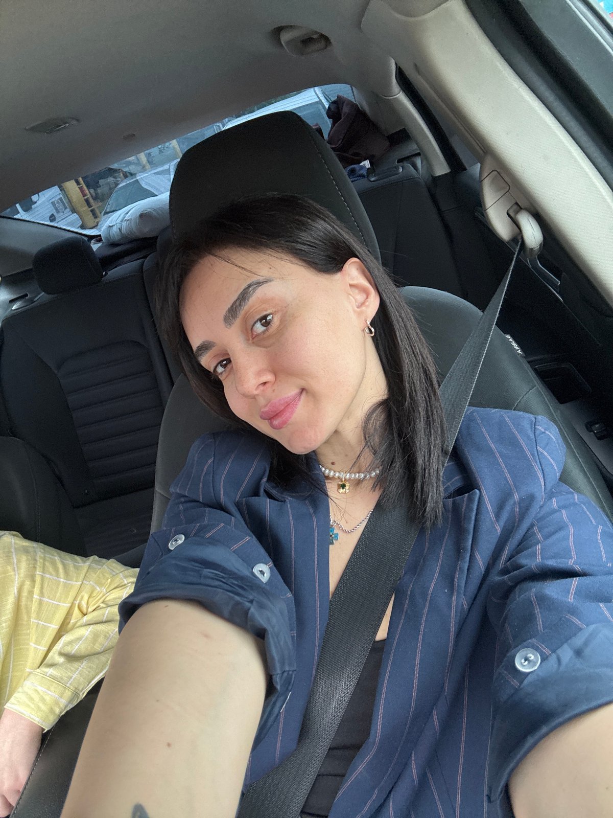 Two women take selfies in car in Tbilisi