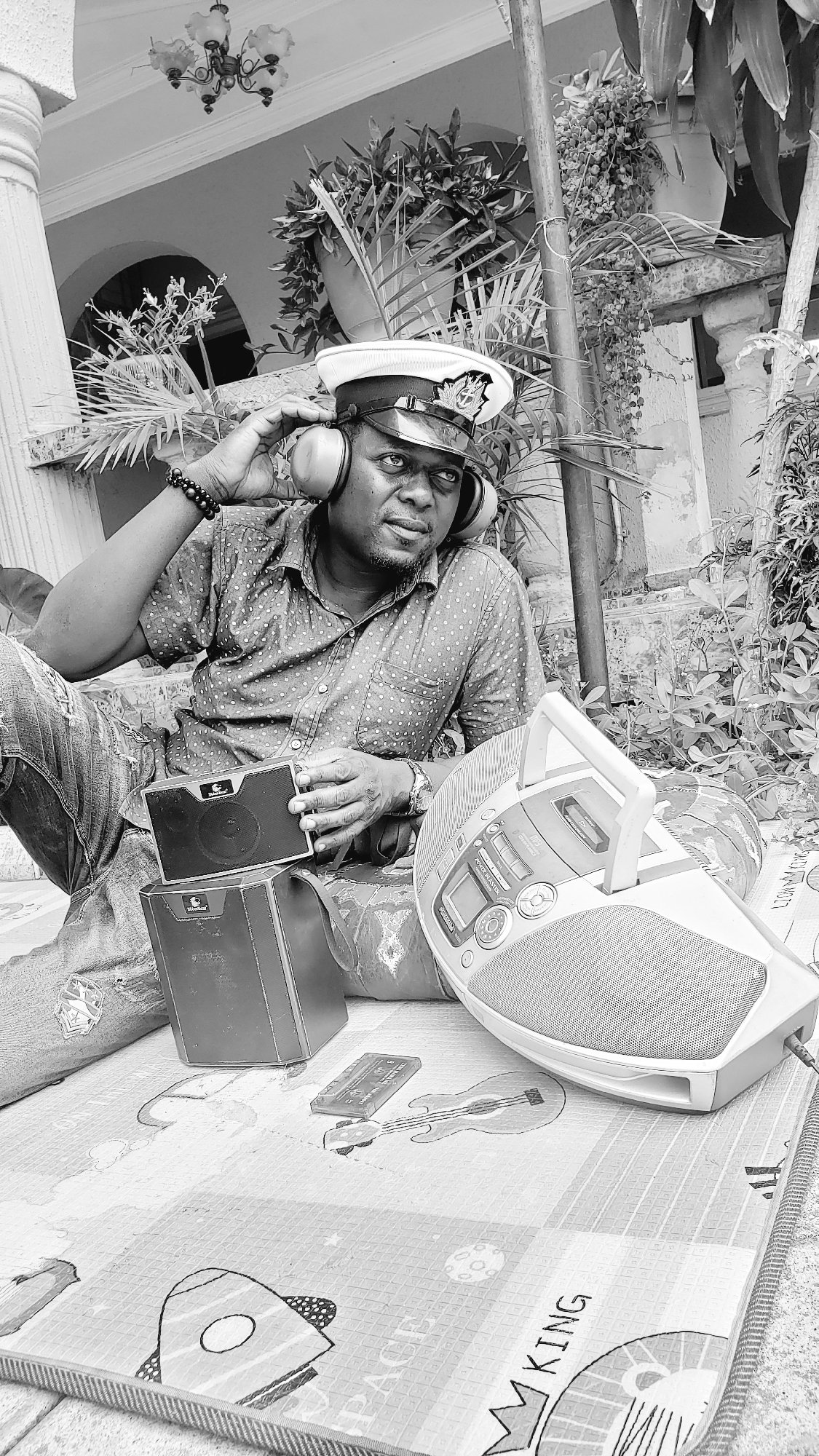 Man enjoys music with boombox outdoors in Sabon Tasha