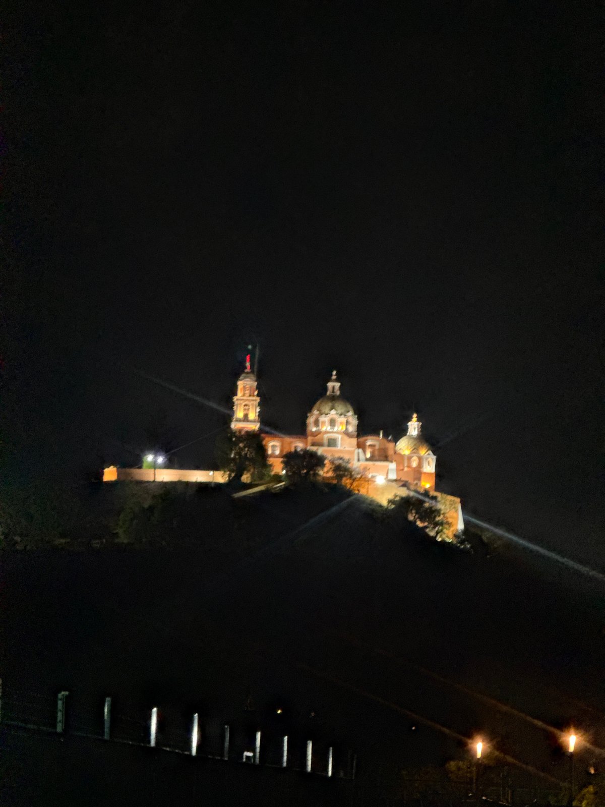 Nighttime photography captures illuminated Mexican church sanctuary
