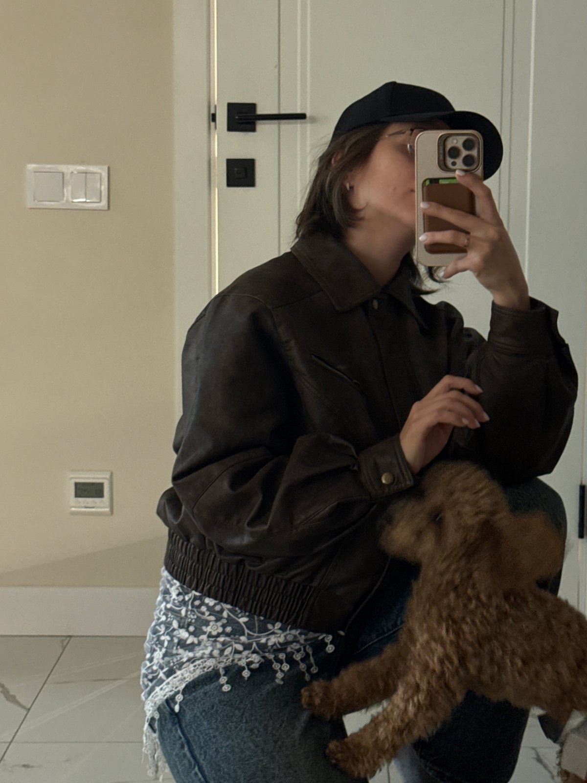 Person takes mirror selfies with dog in Pervomaysky home