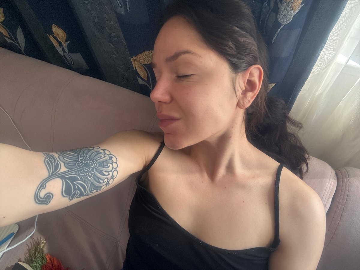 Woman rests on couch in Burgas indoor setting