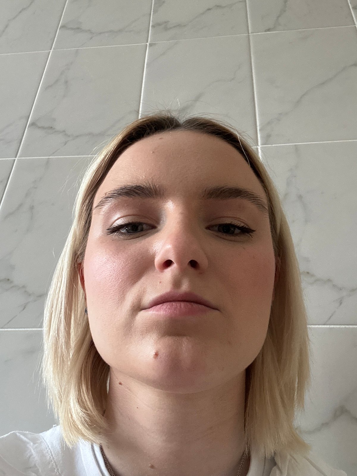 Person takes close-up selfies in Saint Petersburg bathroom