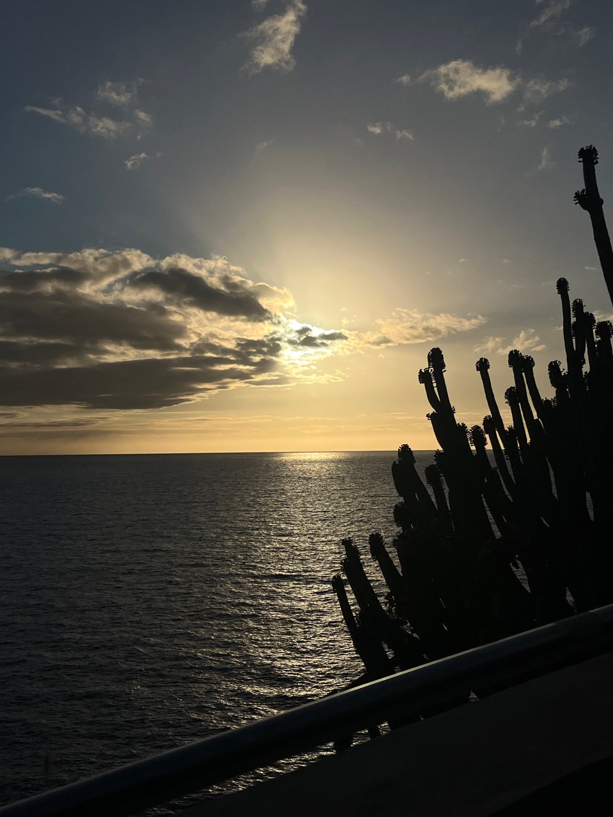 Clouded sunset observed over water in Mogán, Spain