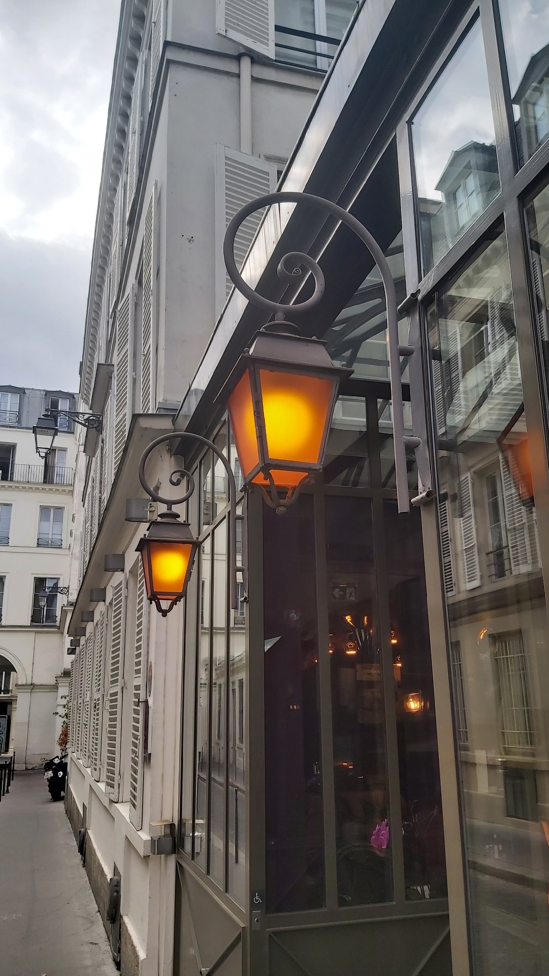 Street-level and rooftop views across a Haussmannian Paris neighborhood