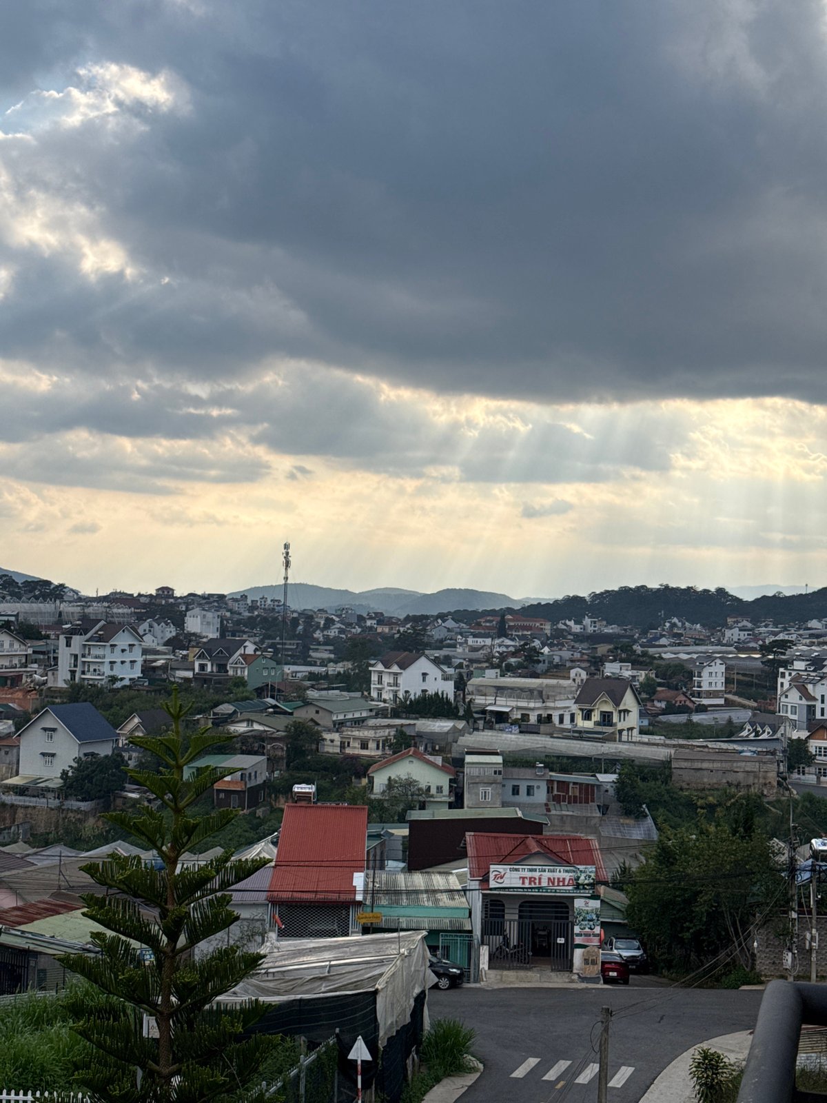 Dramatic sunbeams pierce storm clouds over Đà Lạt, Vietnam