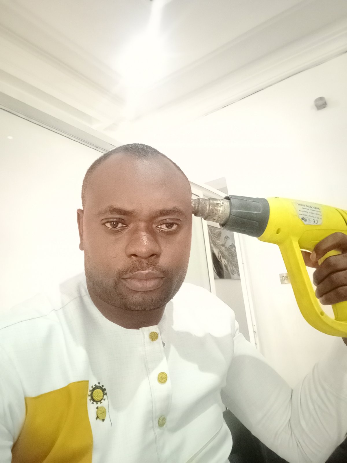 Man photographed in multiple poses indoors in Gwarinpa
