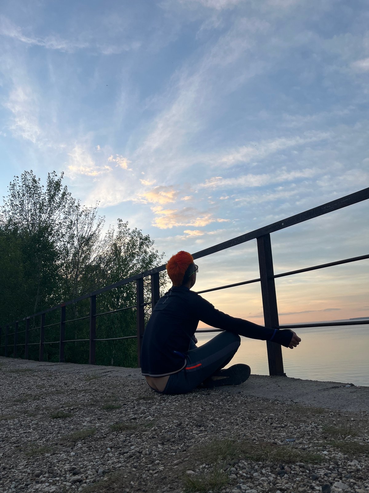 Person with orange hair sits on ledge in Chaikovsky