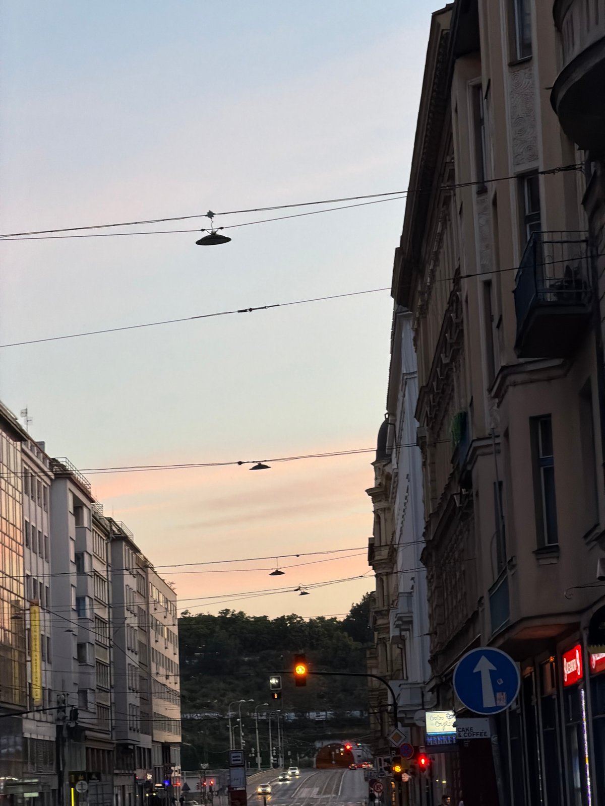Prague streets at golden hour, moon still hanging in the sky