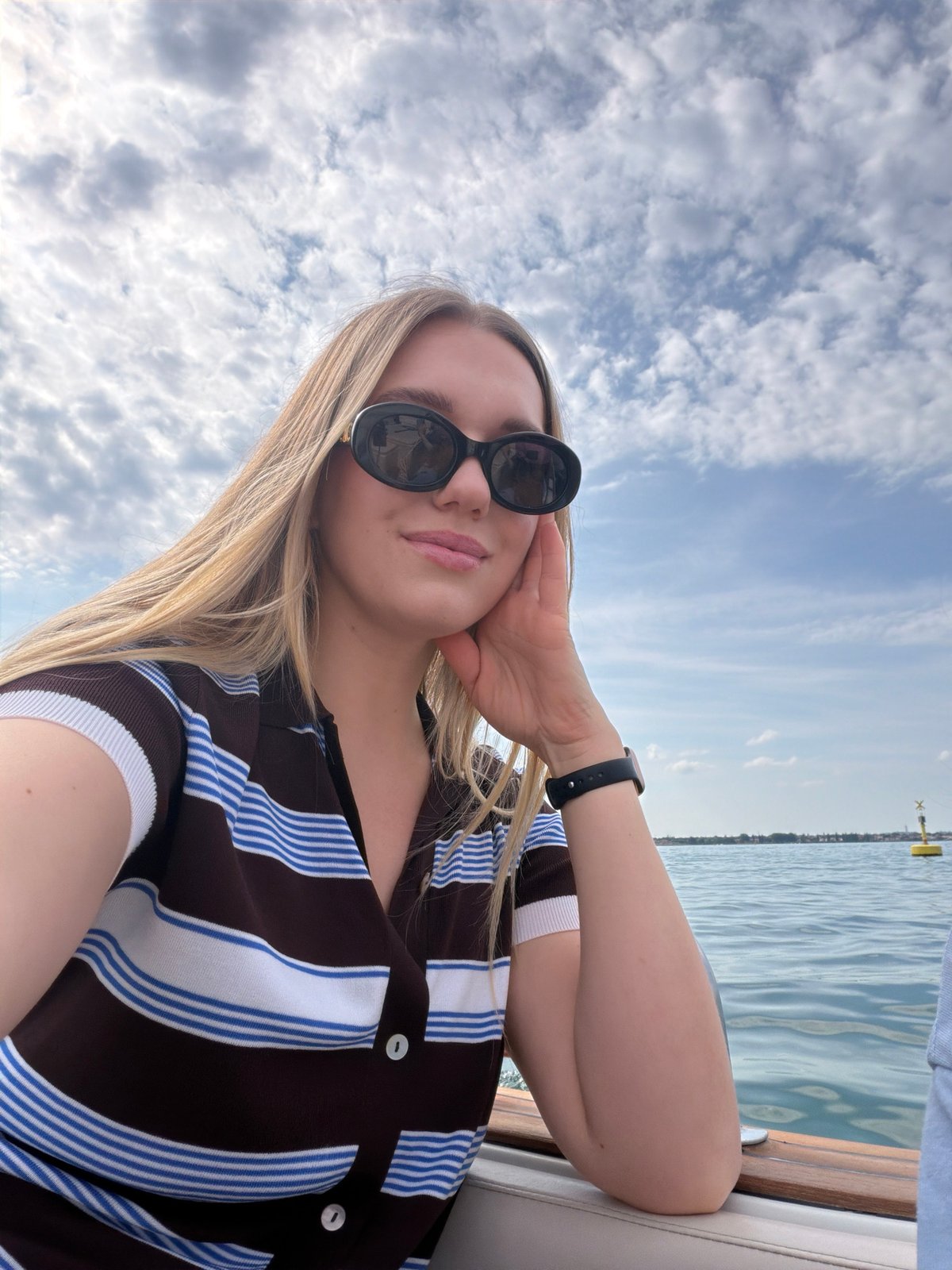 Woman takes boat selfies in Sirmione, Italy