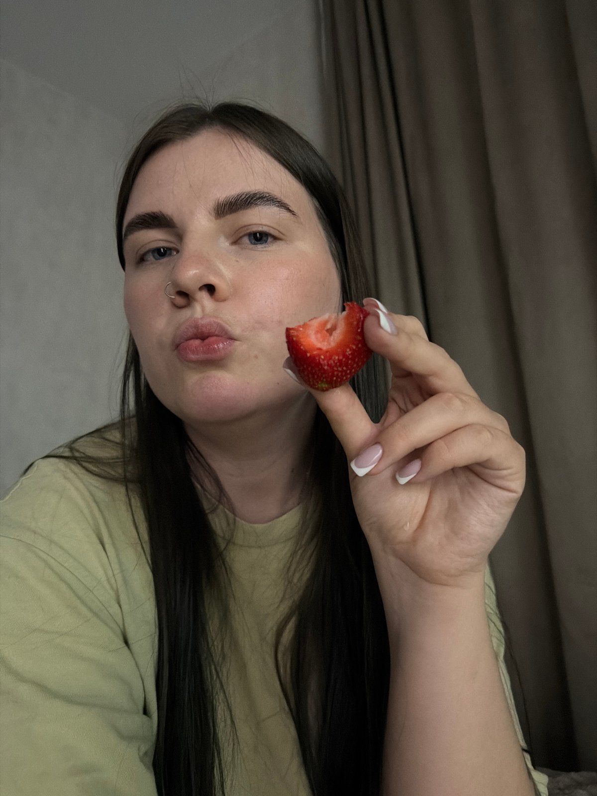 Woman eating strawberry observed in Chaikovsky, Russia