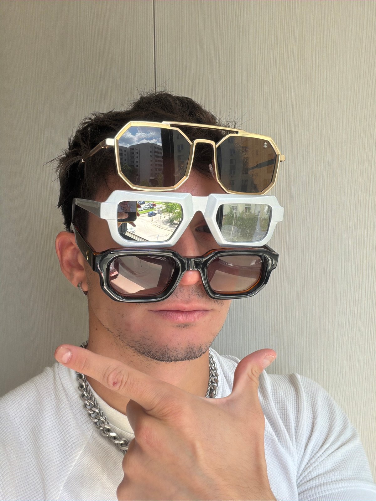 Man wears three pairs of sunglasses in Sofia fashion photos