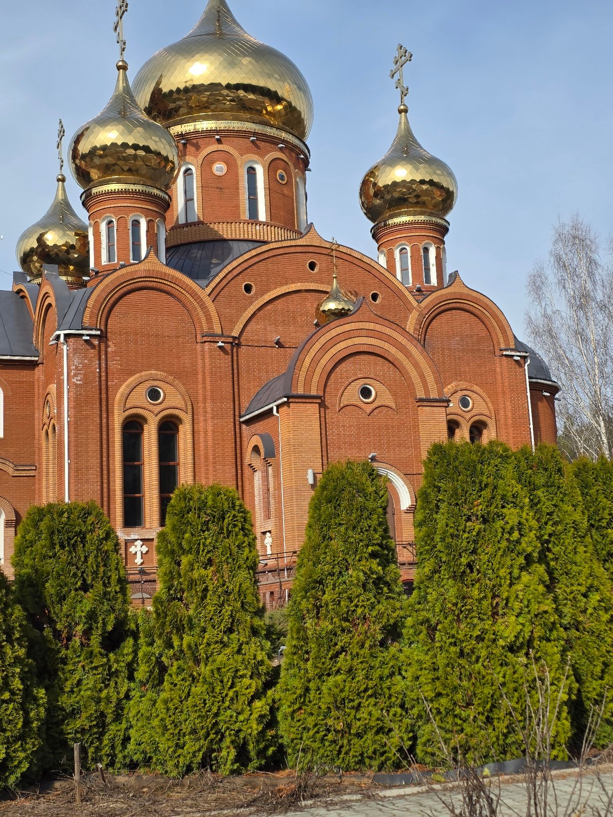 Child plays soccer near Orthodox cathedral in Chaikovsky, Russia