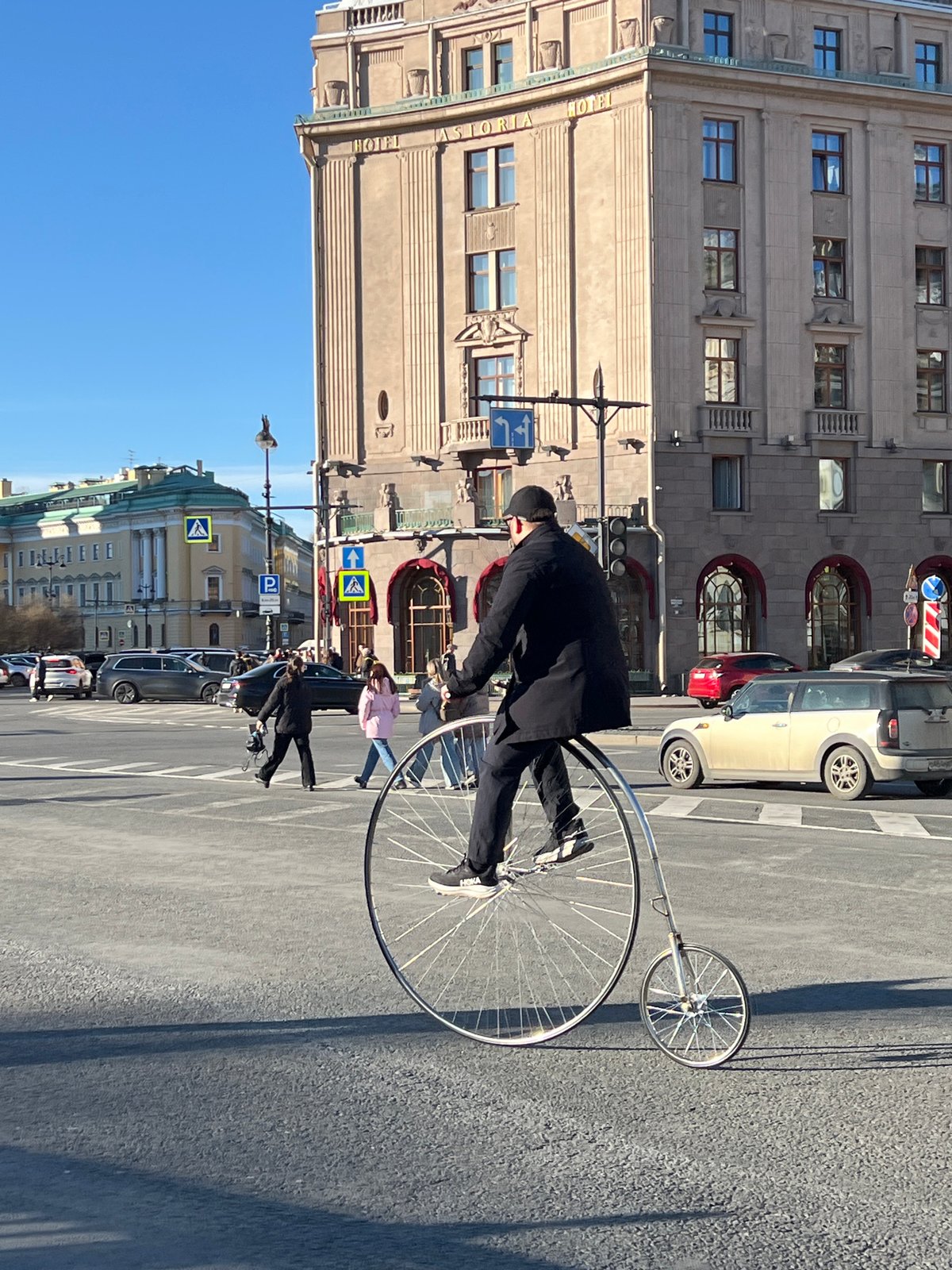 Man rides vintage penny-farthing bicycle through Saint Petersburg streets