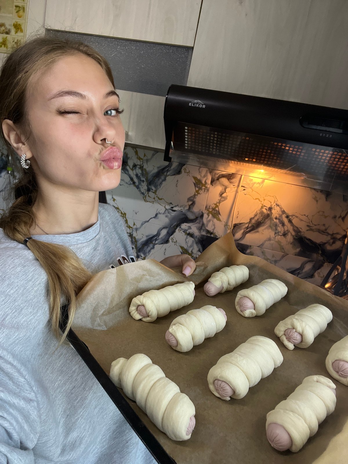 Woman prepares pigs in blanket for early morning baking