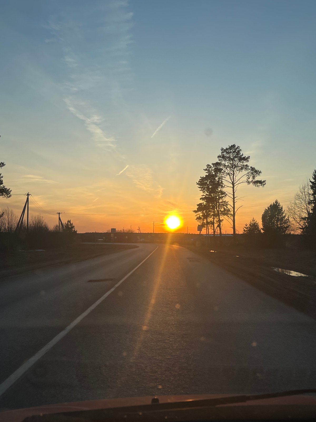 Sunset documented on rural road in Гаревая, Russia