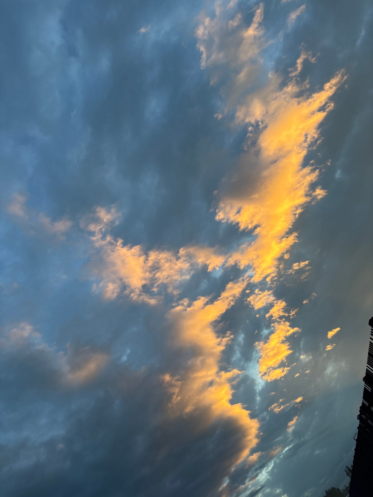 Young people socialize outdoors during dramatic sunset in Russia