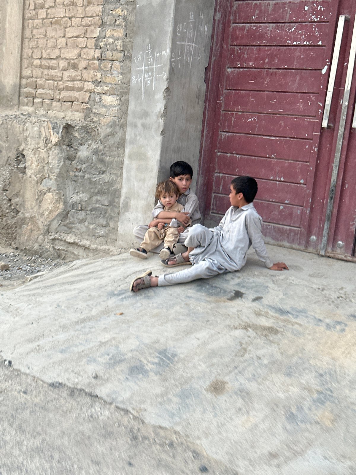 Street scenes from Quetta: a doorway moment and a motorcycle ride