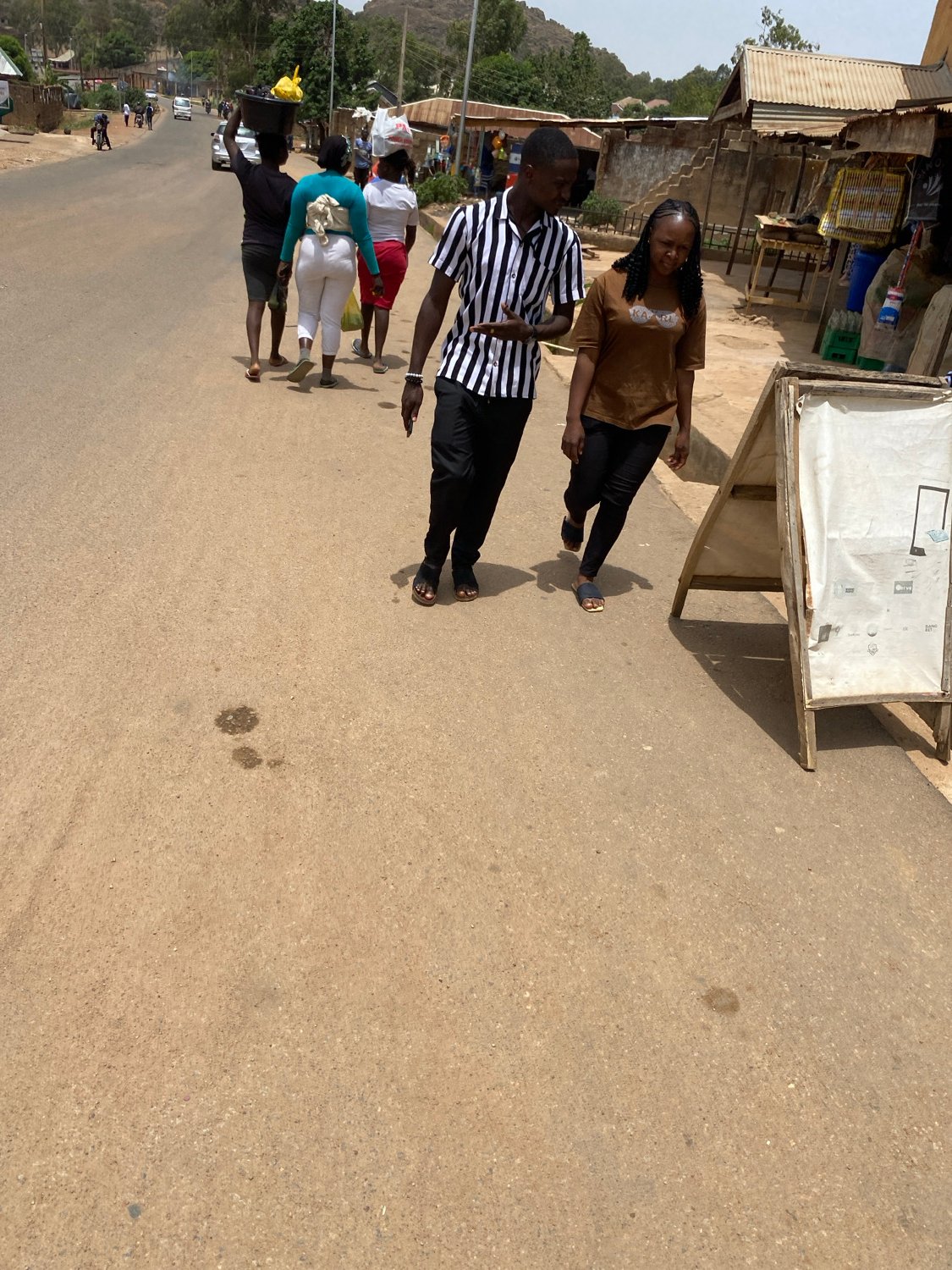 Daily life unfolds on sunny Jos streets