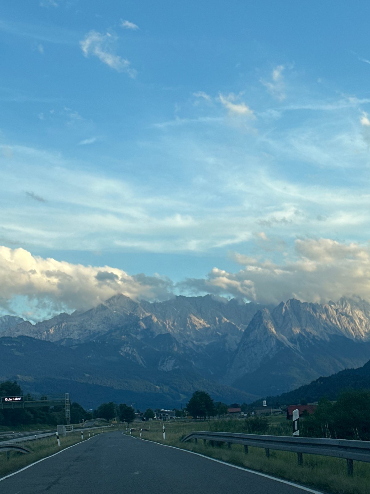 Winding road leads into the cloud-draped Bavarian Alps