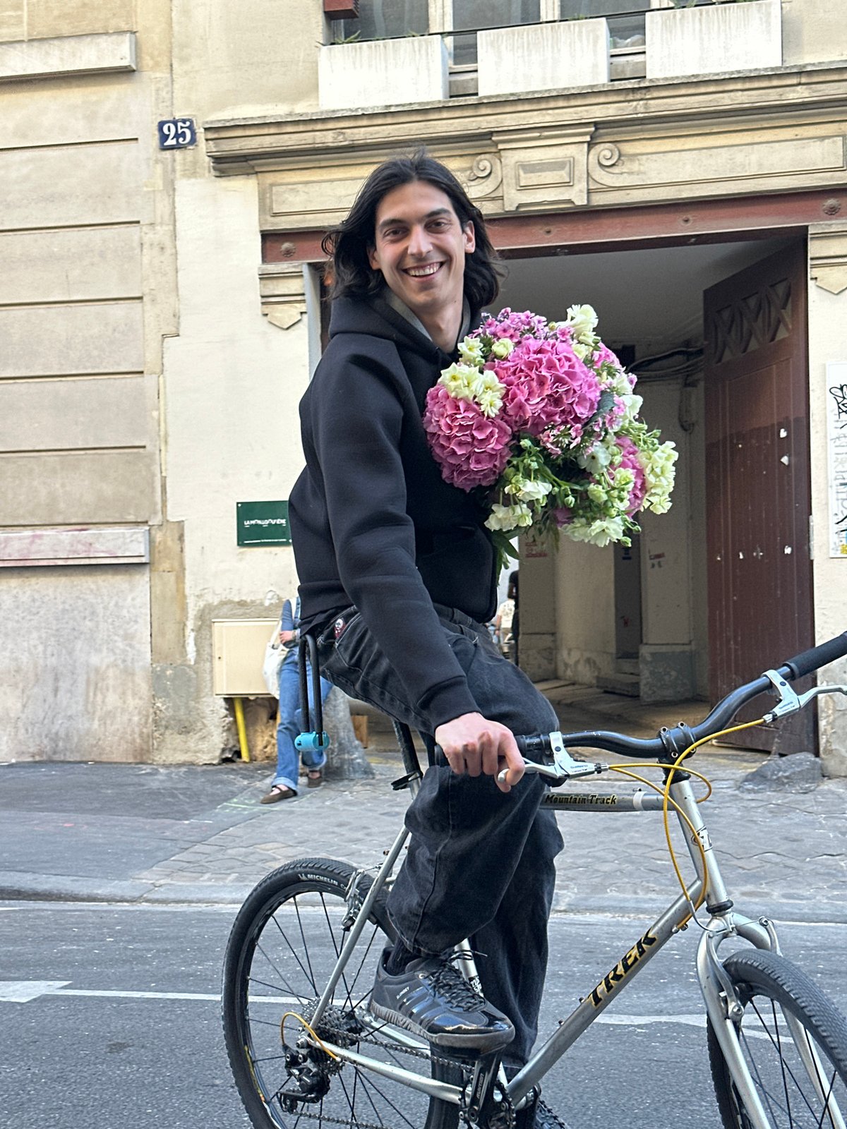 Cyclist with flowers spotted on narrow Paris street