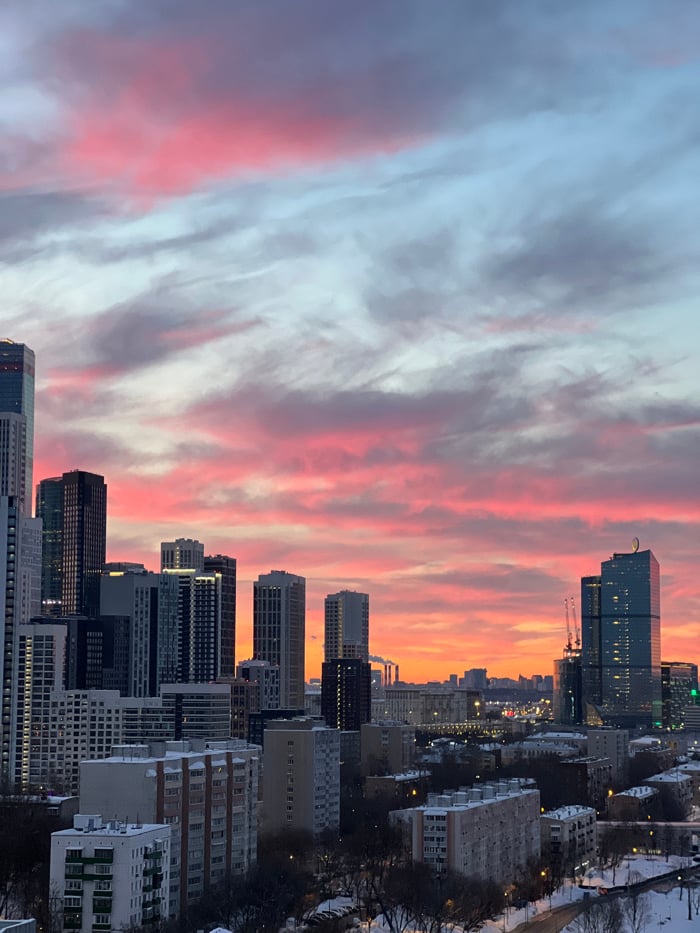 Vibrant sunset illuminates Khimki skyline, witnesses capture colorful display