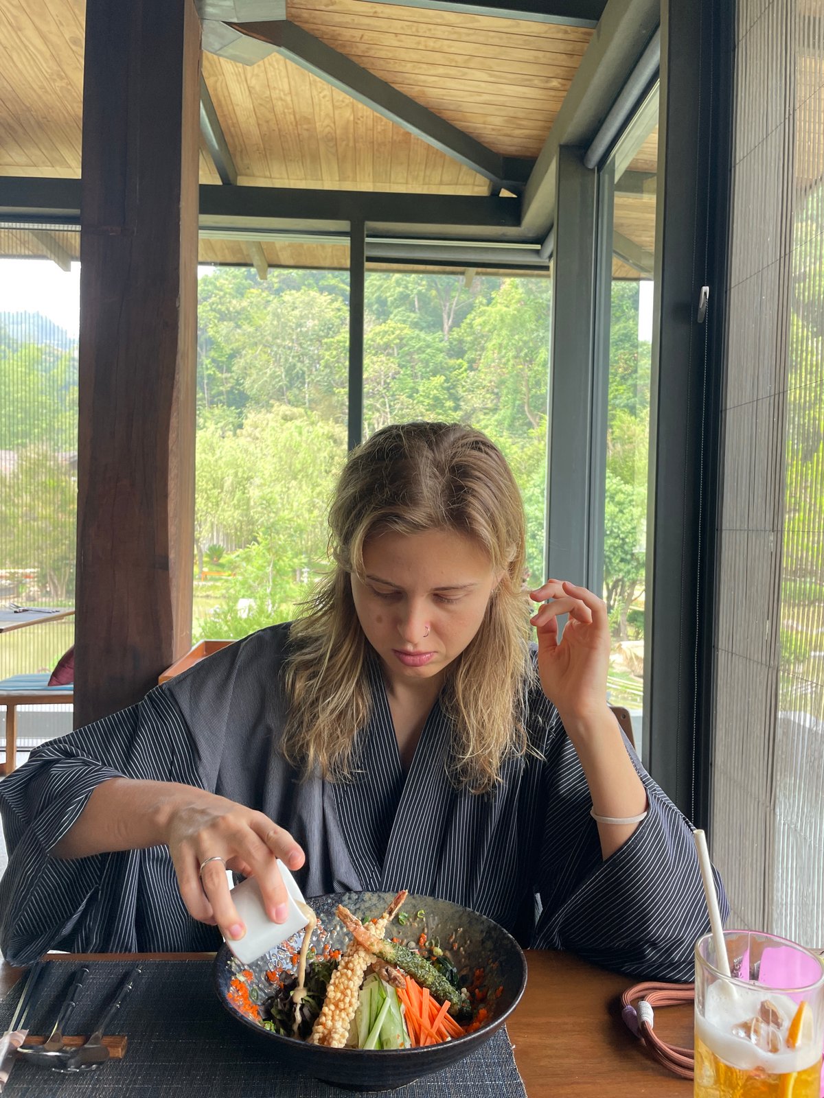 Woman enjoys morning view of lush Thai landscape