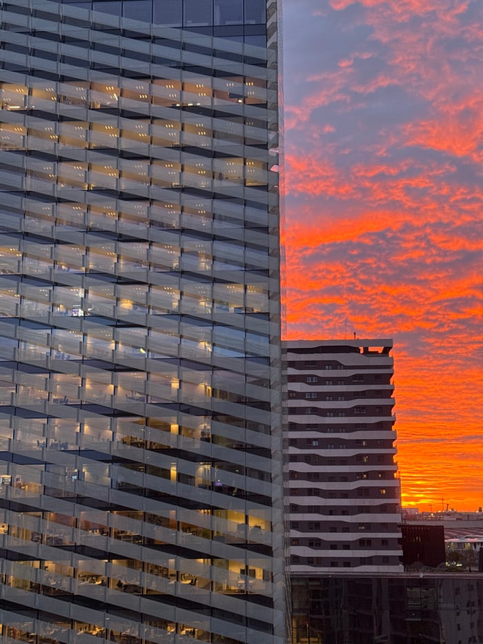 Dramatic sunrise illuminates Barcelona metro skyline with geometric architecture