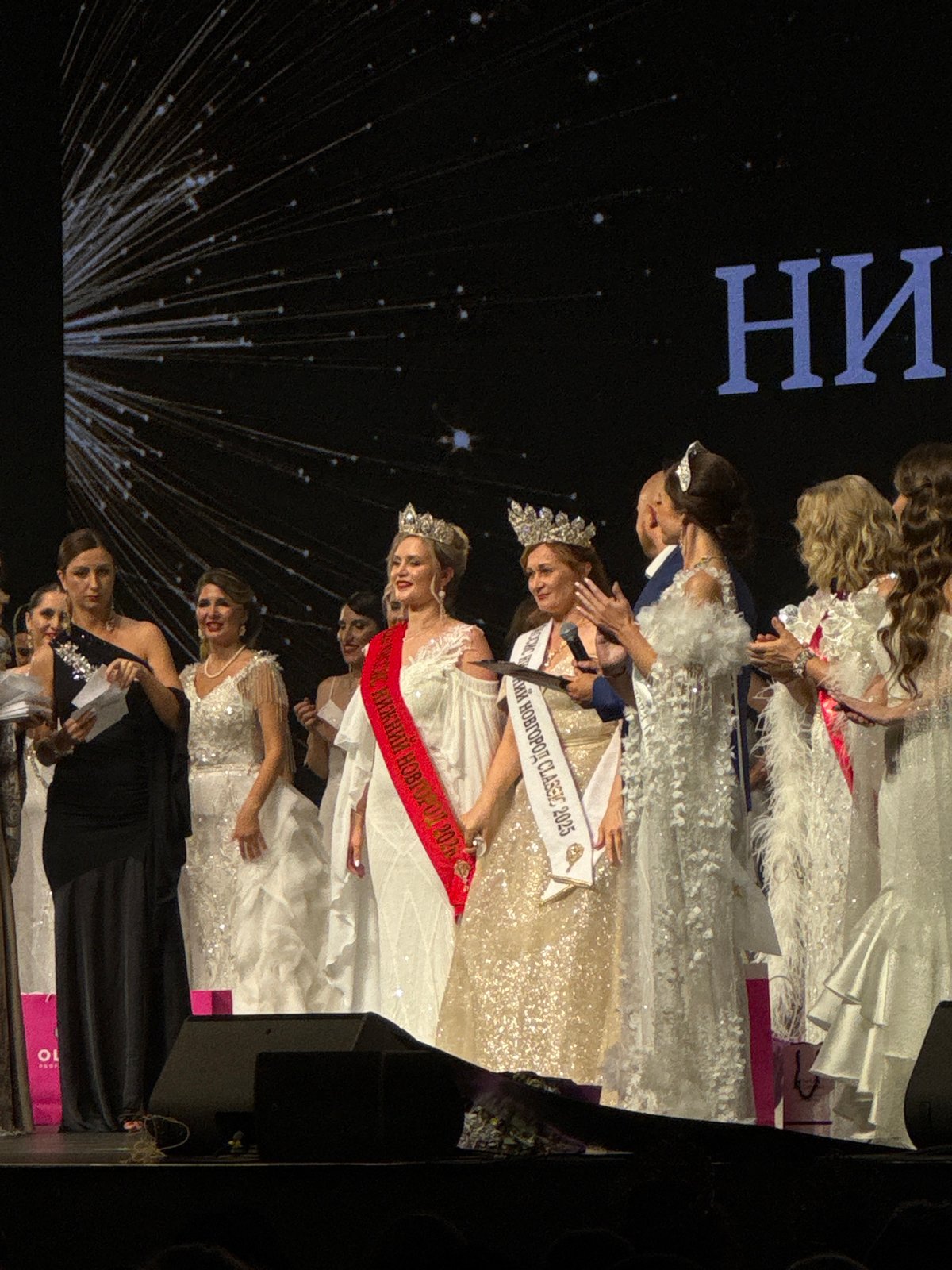 Beauty pageant contestants gather on stage for awards ceremony
