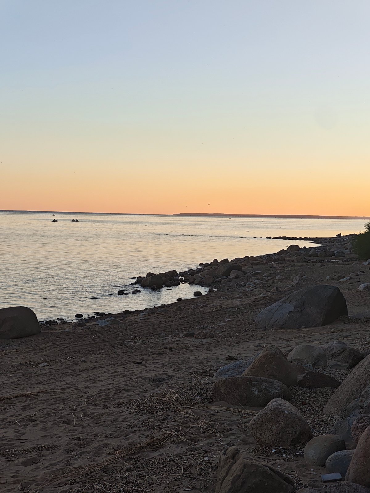 Dusk settles over a calm Gulf of Finland beach in Repino