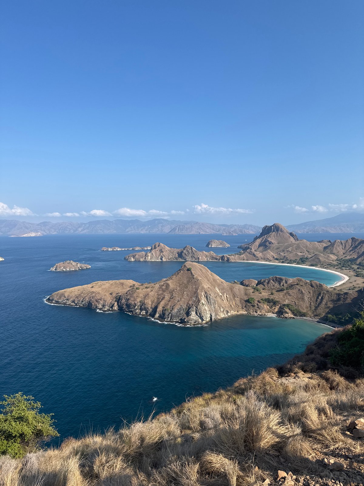 Clifftop views over Indonesia's island-dotted blue waters