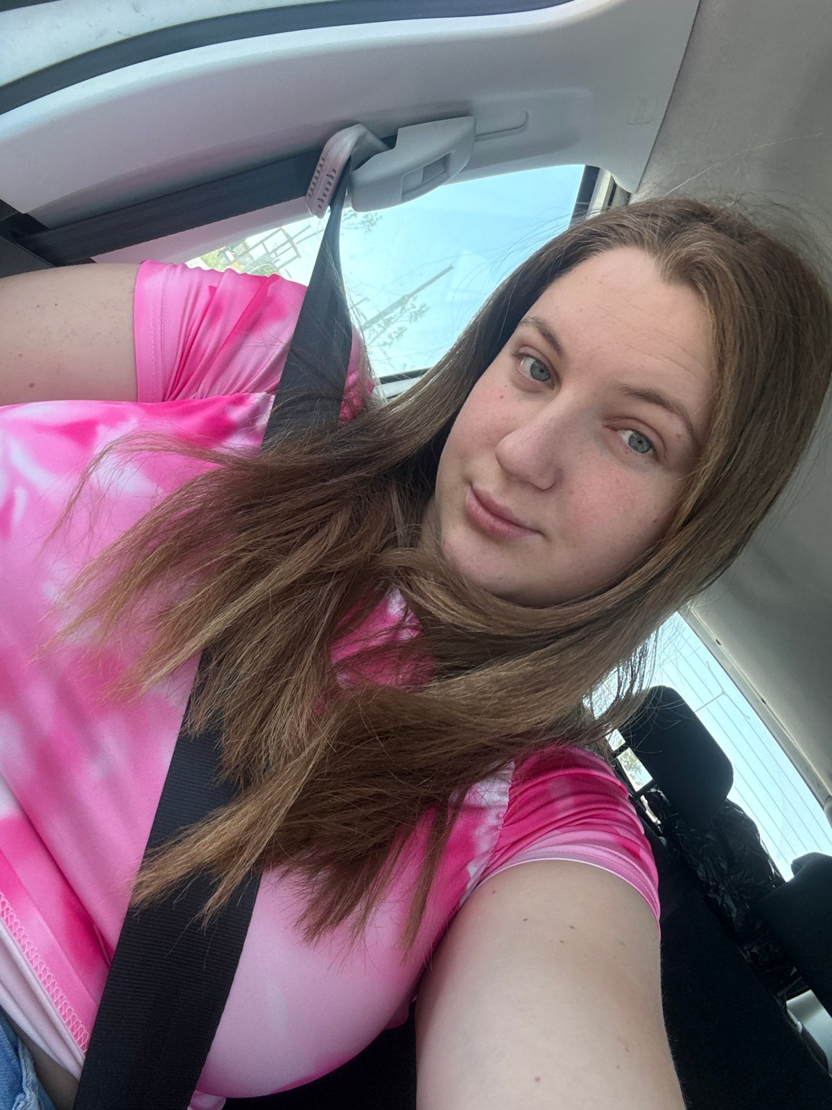 Driver in pink tie-dye waits at red light