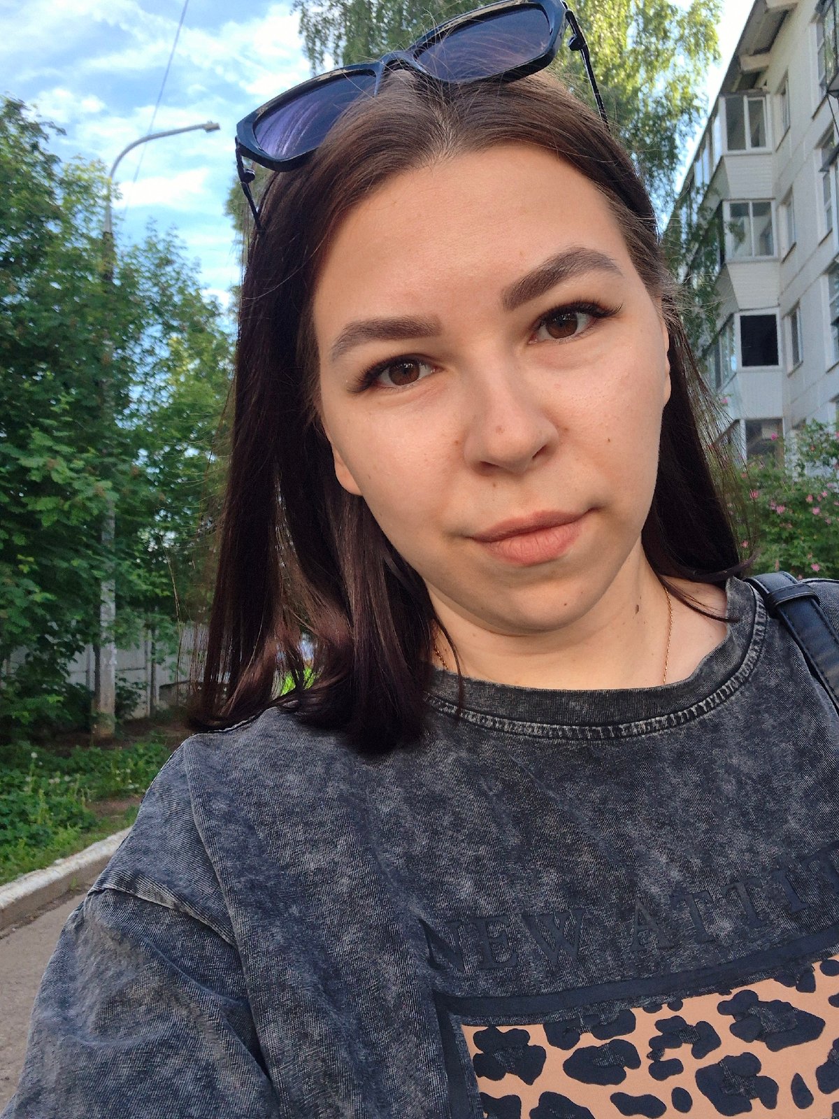 Woman takes selfies in residential Chaikovsky during early morning