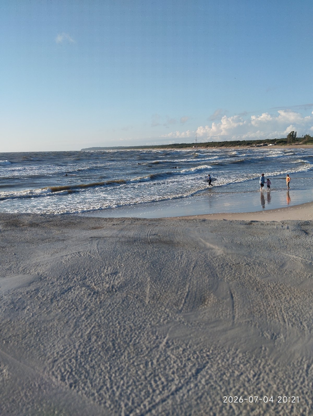 Surfing and swimming on a choppy Baltic Sea afternoon