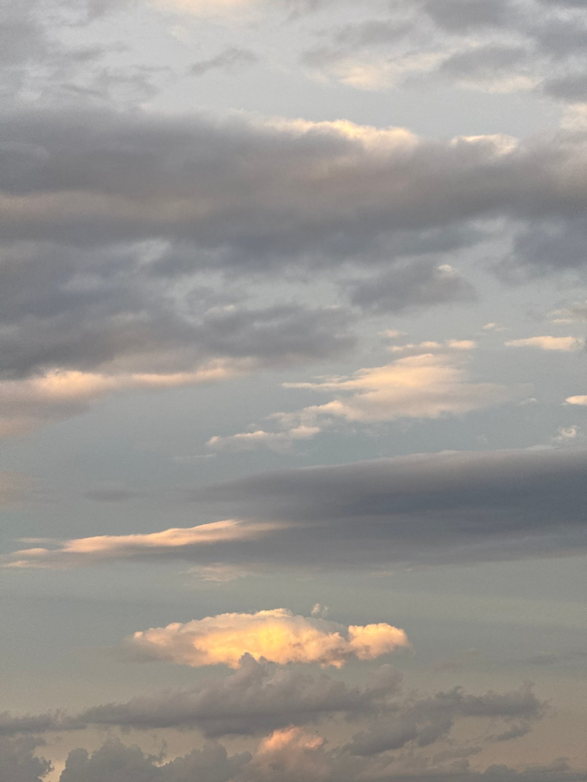 Dramatic golden-lit clouds observed over city skyline