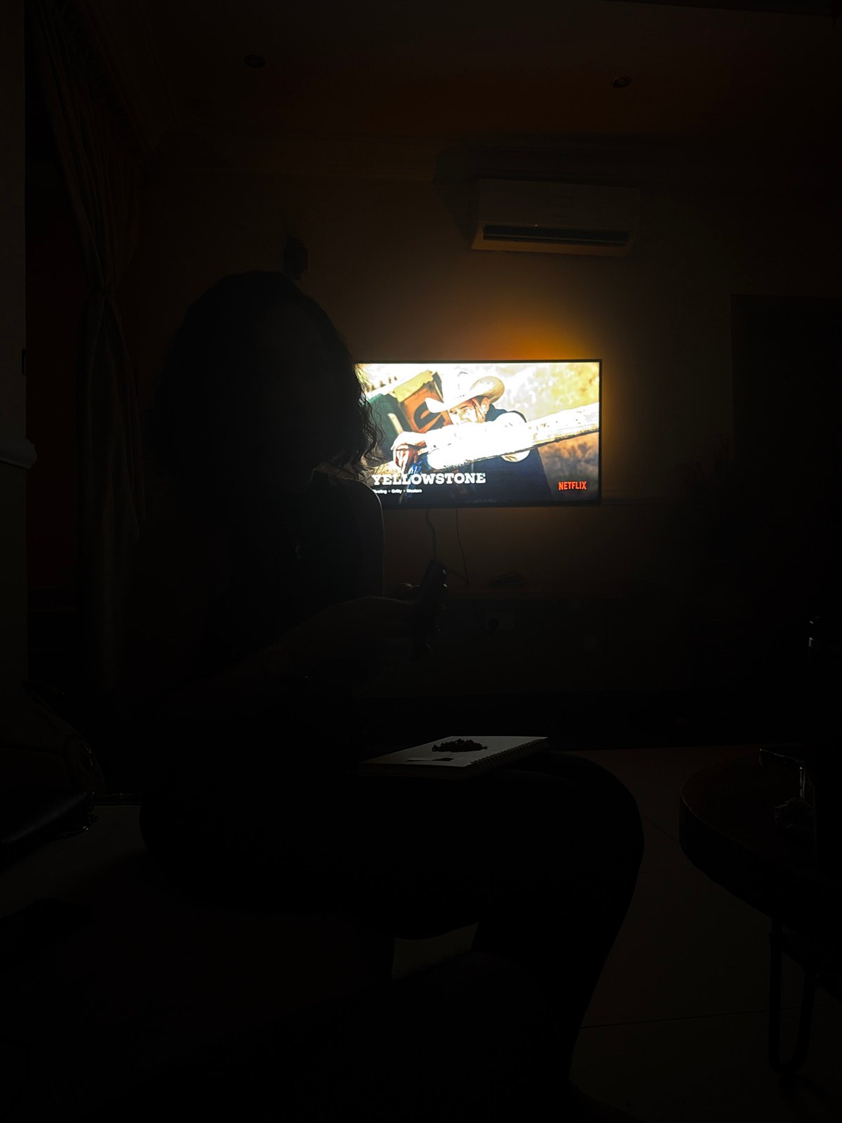 Evening Netflix viewing captured in dimly lit Ojomu home