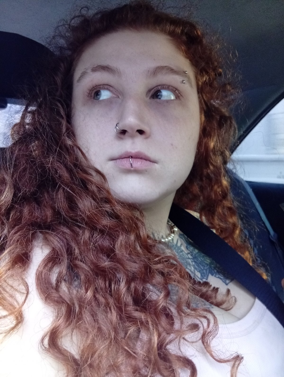 Young woman with piercings spotted in car, Buenos Aires
