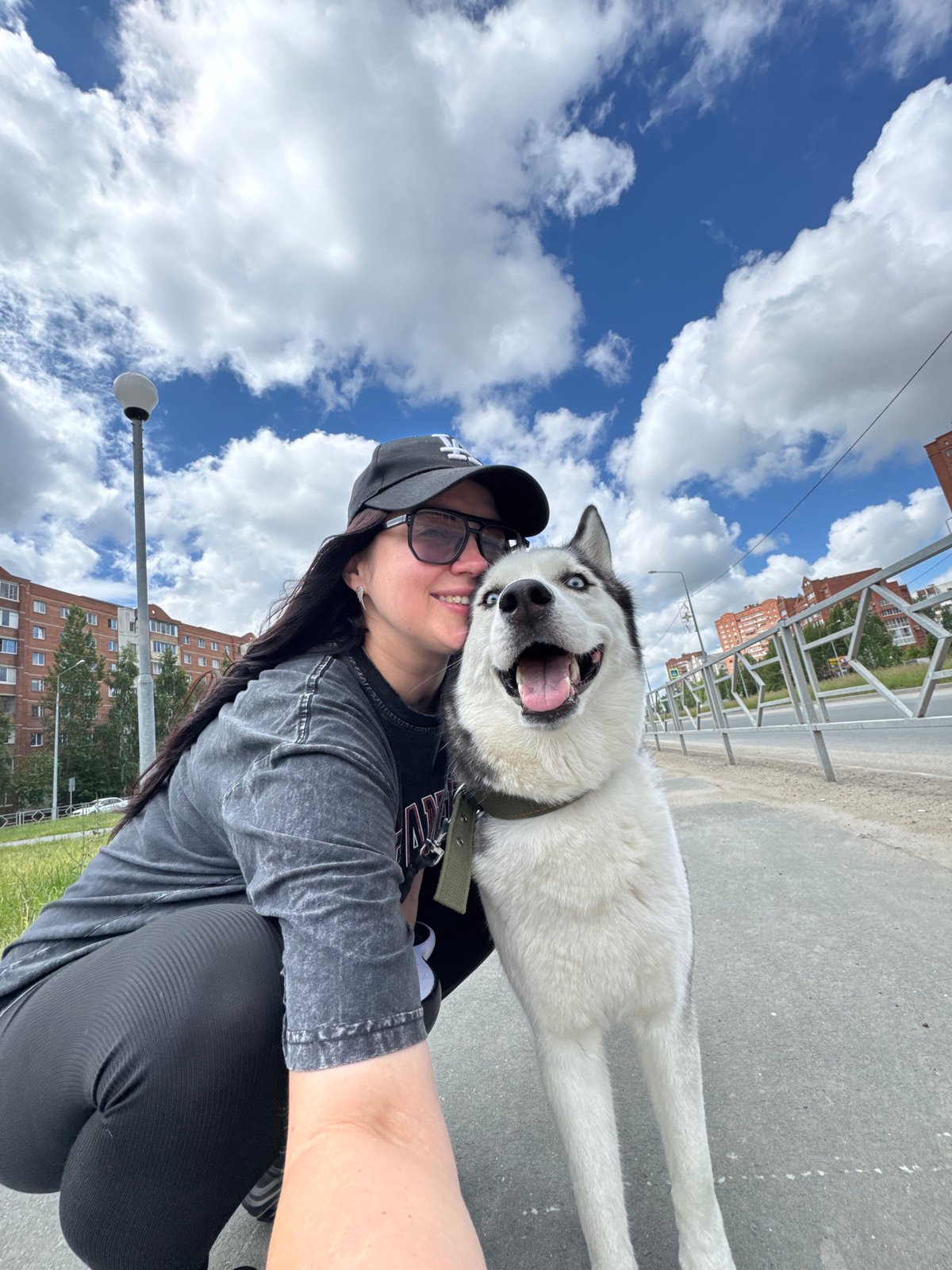 Woman documents morning walk with Husky in outdoor selfie series
