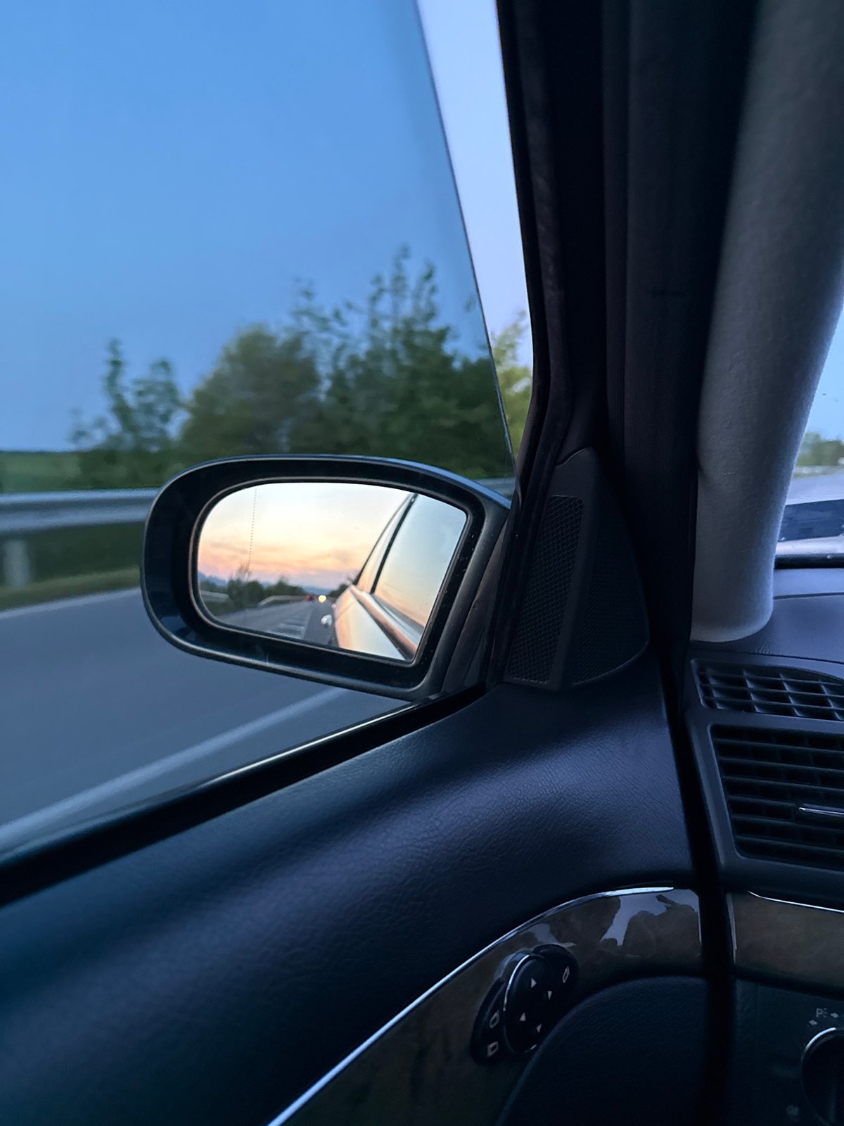 Driver captures sunset road reflections in side mirror, Bulgaria