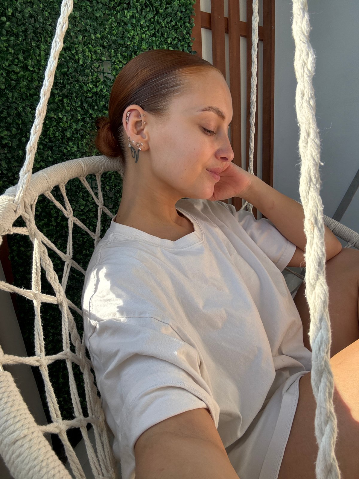 Woman enjoys quiet morning moments in hammock in Chaikovsky
