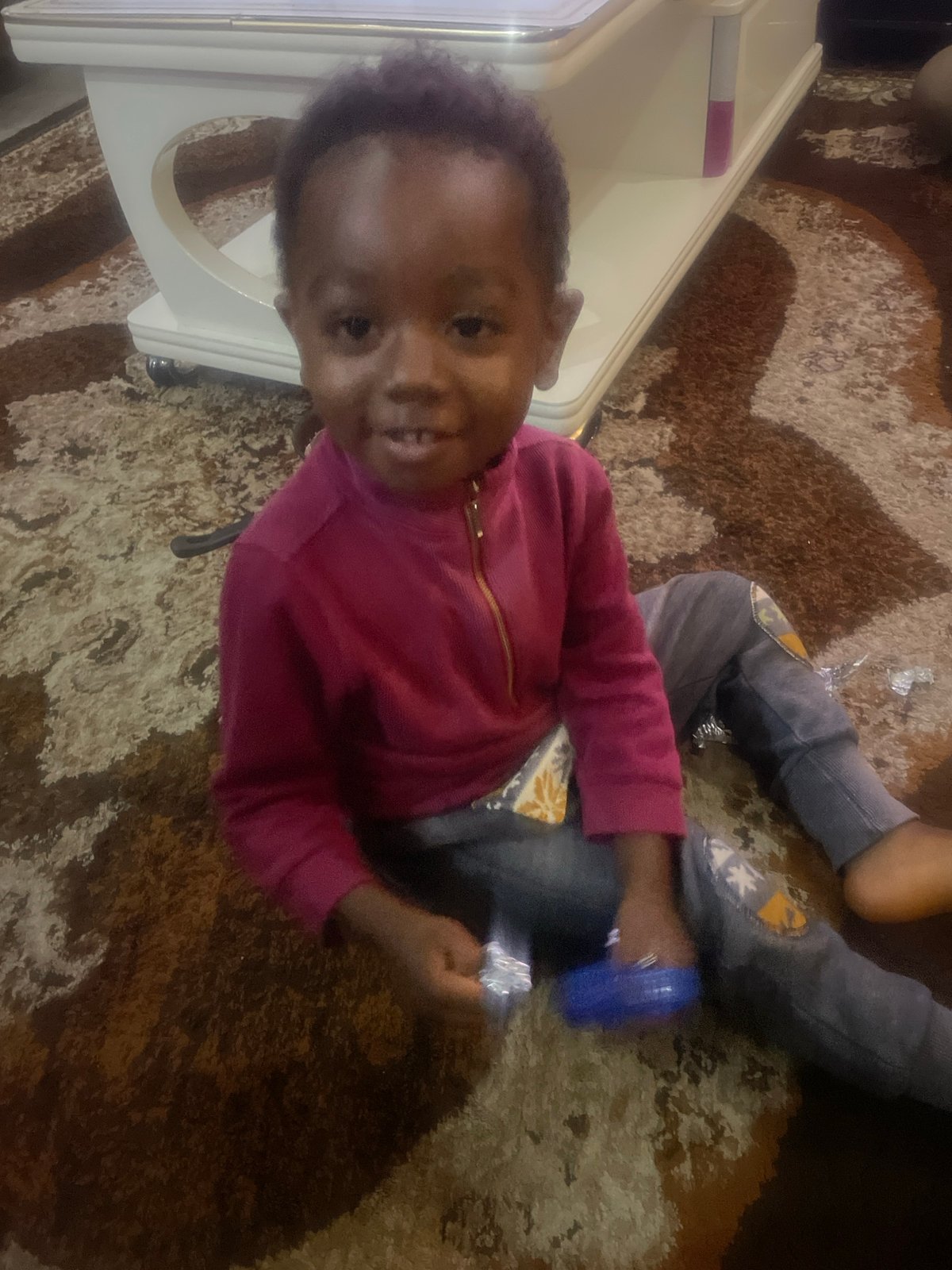 Playtime on a patterned rug in a Nigerian home