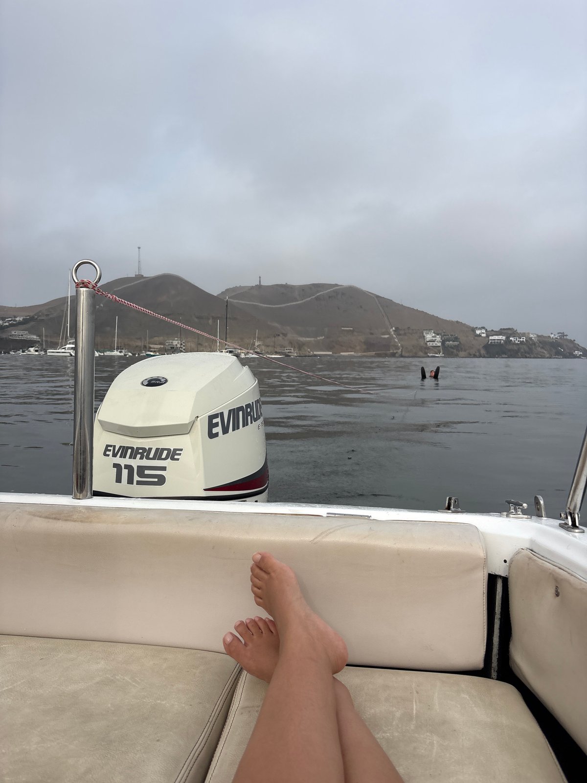 Person relaxes on boat in Ancón Bay, Peru