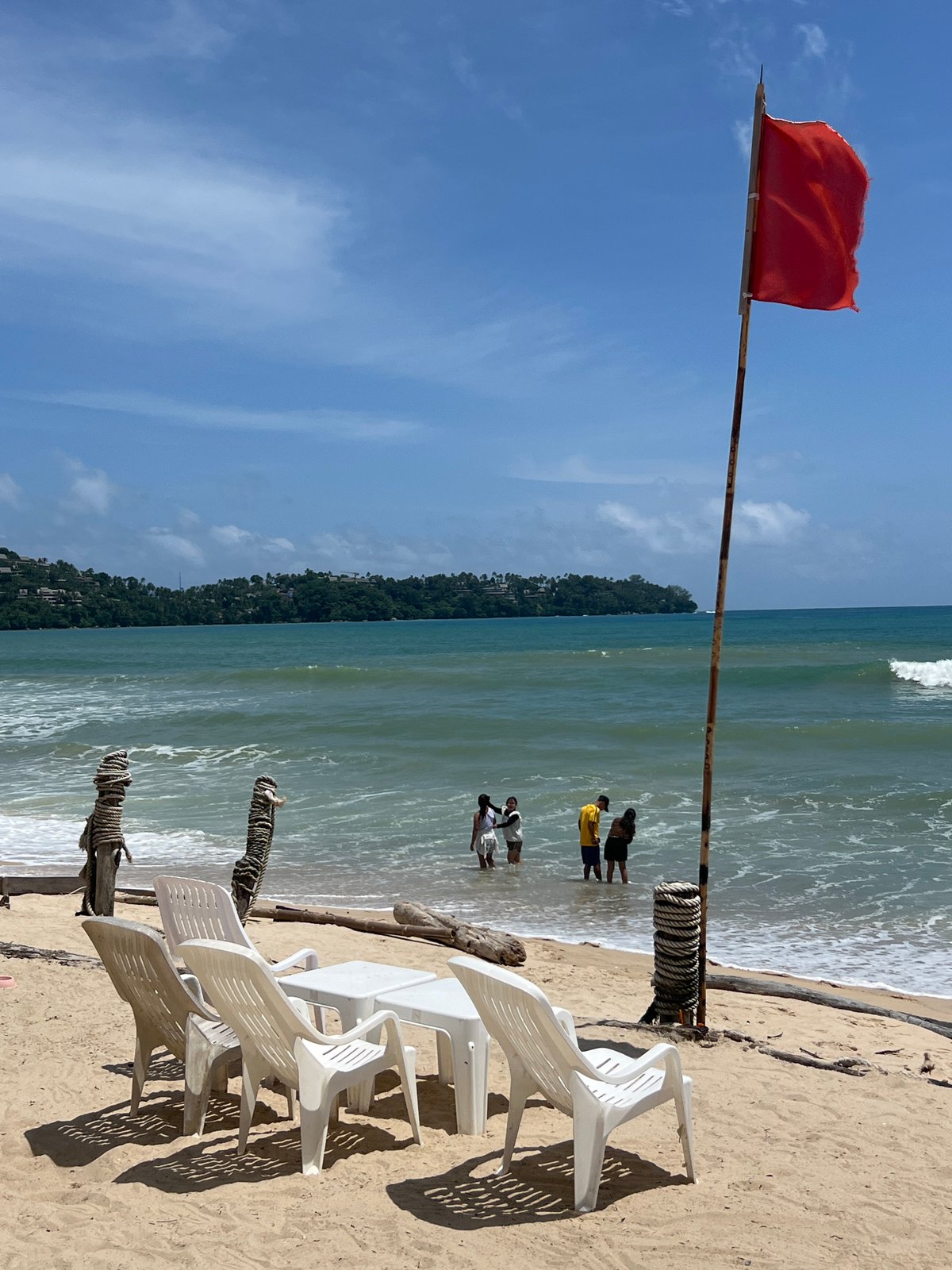 Morning at a Choeng Thale beach with warning flag flying