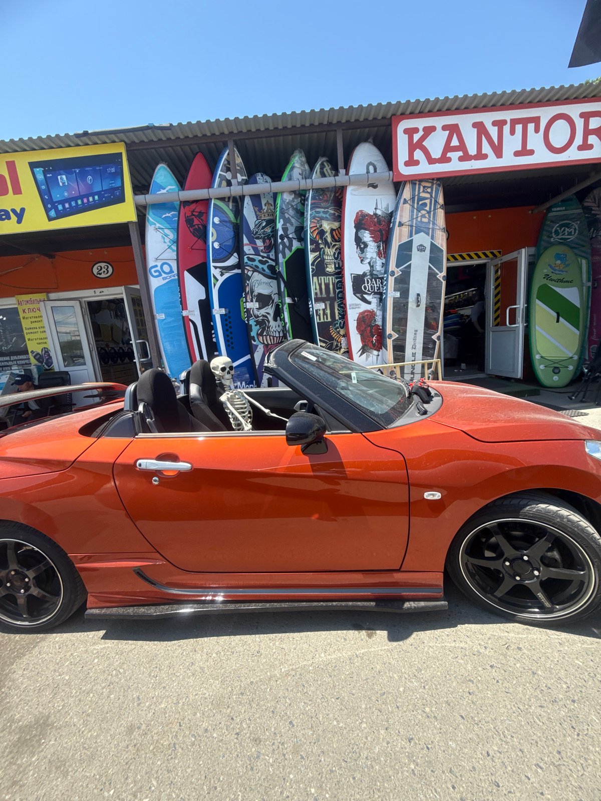 Skeleton figure spotted in orange convertible outside Vladivostok surf shop