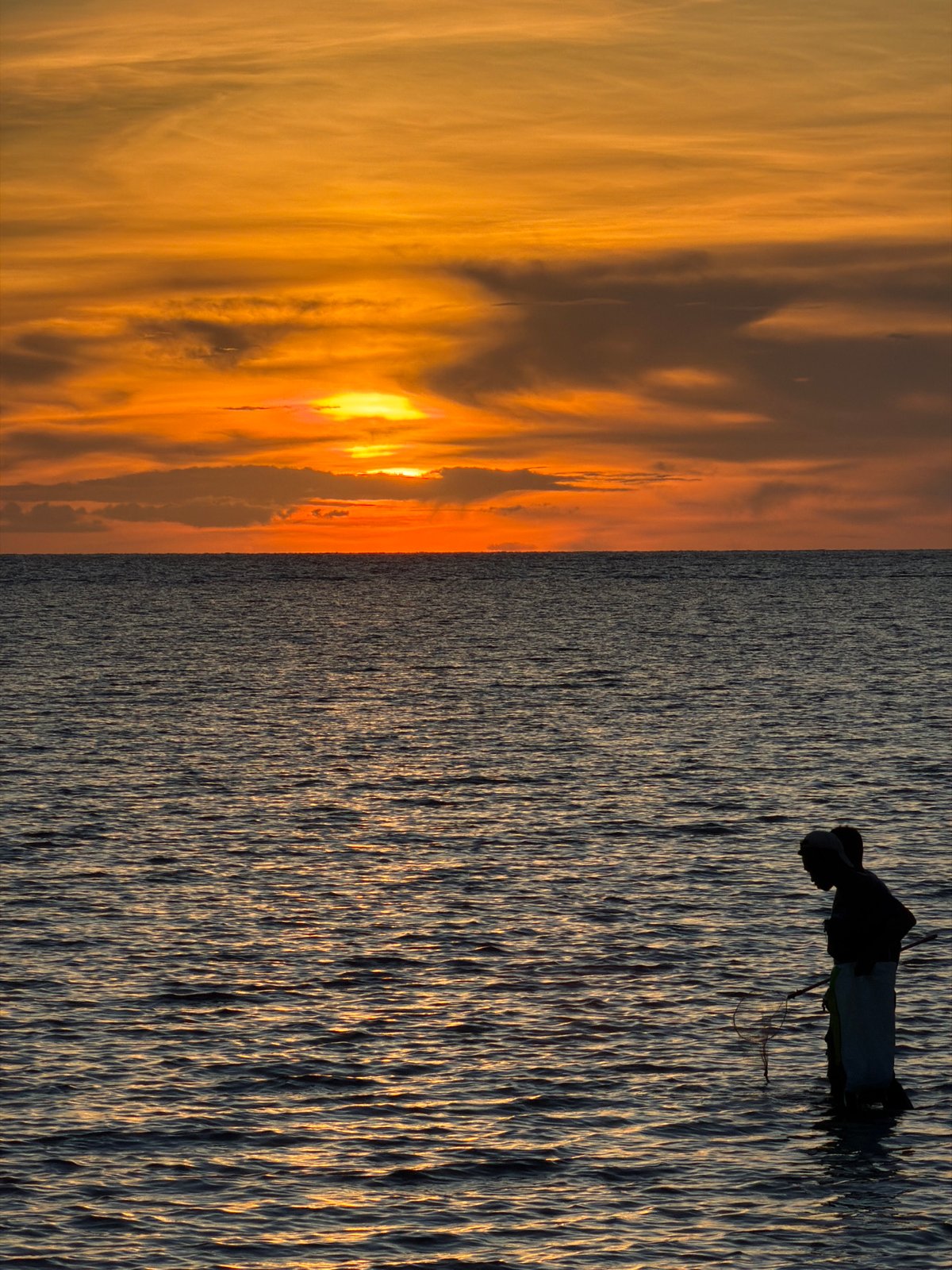 Choeng Mon beach at golden hour, palms and figures in the shallows
