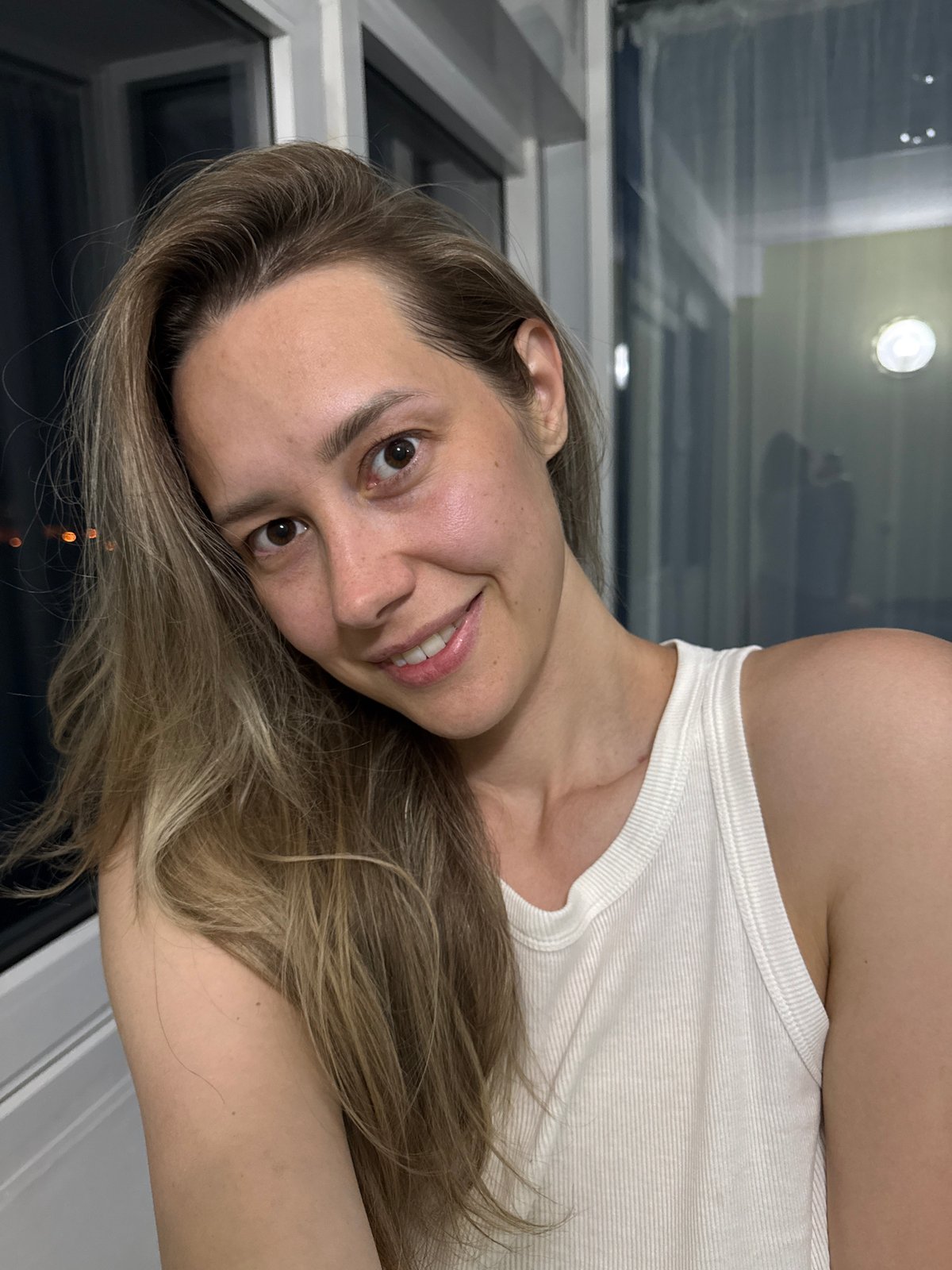 Woman takes selfie on balcony in Nebug, Russia